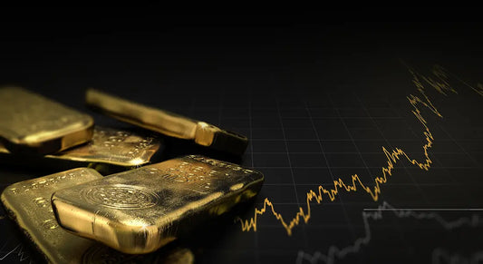 Goldbarren vor Börsencharts